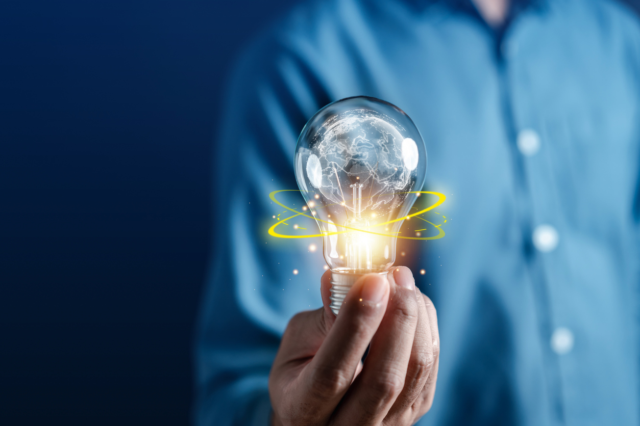 Hand man holding illuminated lightbulb, idea, Global innovation and inspiration with glowing virtual brain, smart intelligent creativity with bulbs, Motivation and innovation concept.