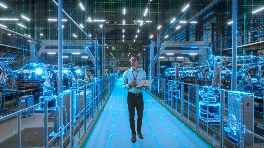 Engineer With Laptop Activates Autonomous EV Factory Digitization. Visualization Shows Robotic Arms, Assembly Line, Digital Twin Lines of Data, Computer Vision Transformation Manufacturing Technology
