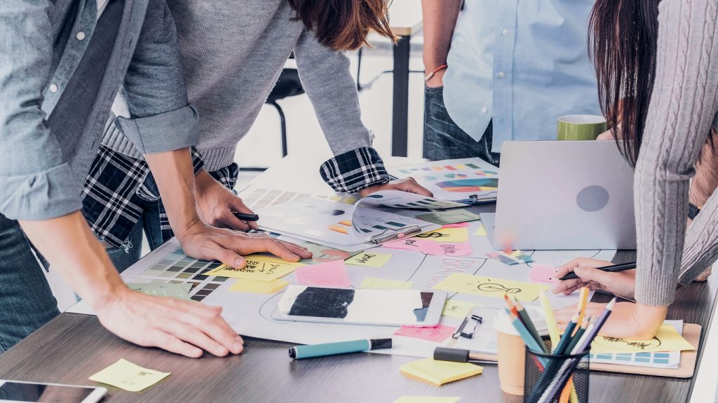 Close up creative designer applaud for job success at meeting table at office