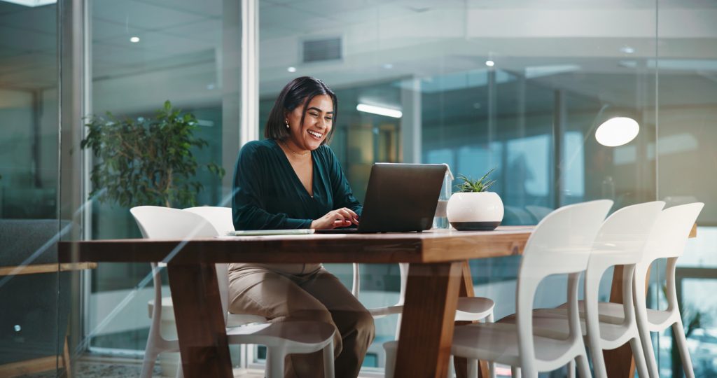 Laptop, research and smile with business woman in office for social media agency, branding and email. Marketing campaign, project launch and client feedback with person in startup for planning