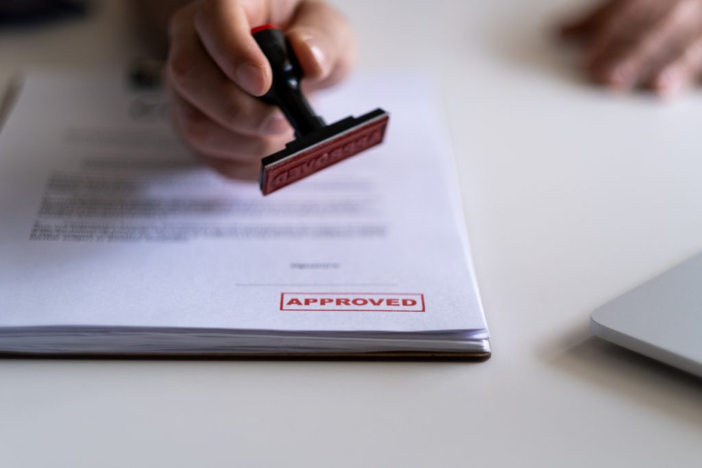 Lending concept. Pre-approved mortgage loan. Business Man Stamping With Approved Stamp On Document. Business approve Stamp and certificate concept. Businessman Hands Stamping a document